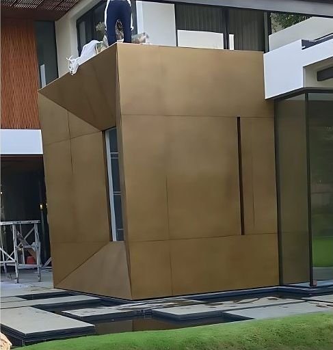 Antique brass clad architectural volume outside a residence
