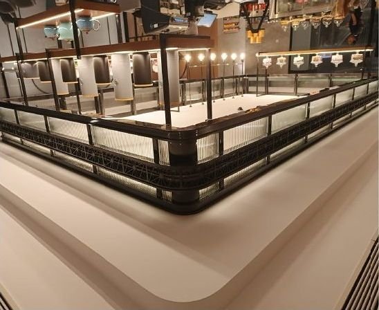 Blackened steel canopy framing a hotel bar counter