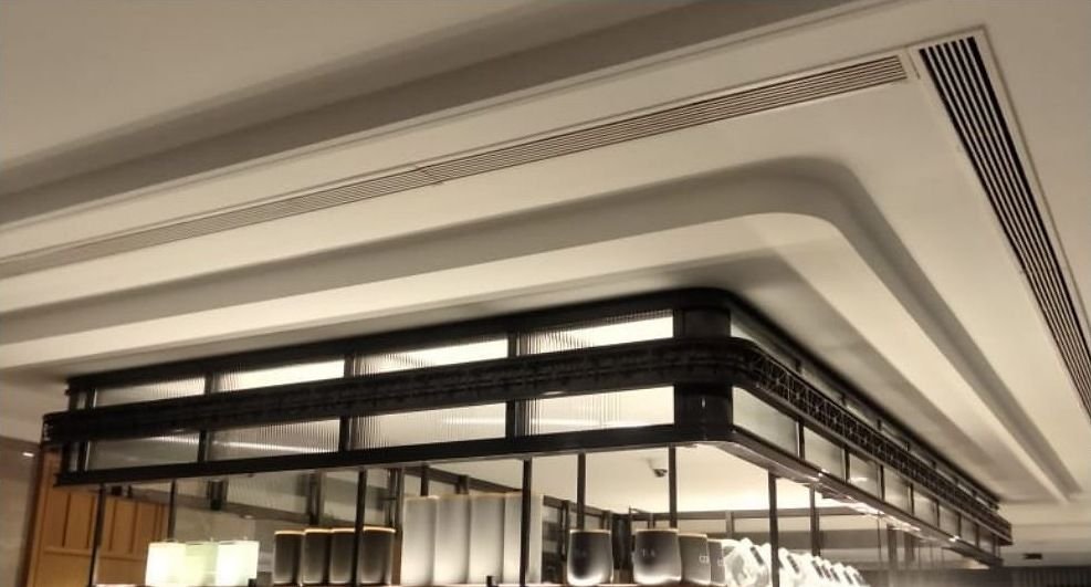 Blackened steel framework detail against a curved plaster ceiling