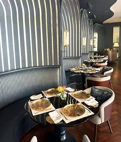 Restaurant seating booth with brass detailing and fluted metal panelling
