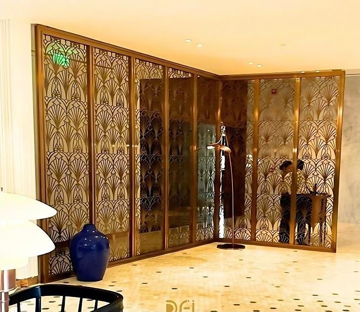 Brass folding screens enclosing a hotel lobby corner