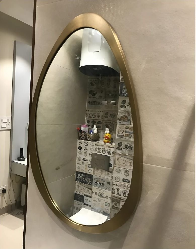 Brass-framed mirror with an organic outline