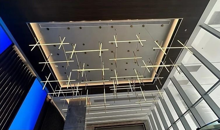 Brass grid feature suspended in a lobby ceiling