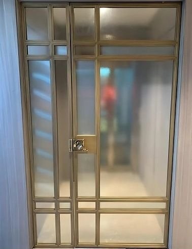 Brass grid entrance door with glazed panels