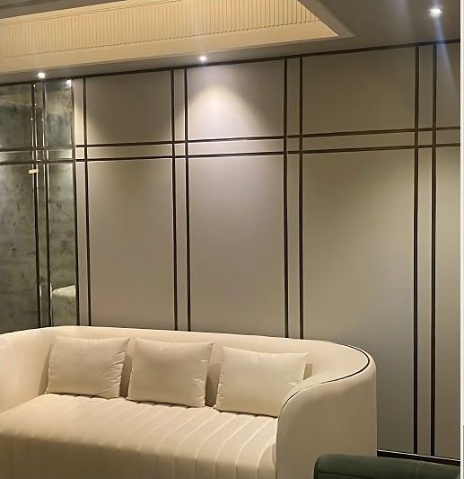 Brass inlay panelled wall behind a bed