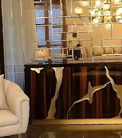Brass inlay sideboard against a mirrored feature wall