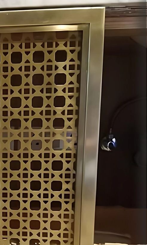 Brass lattice screen set into an interior wall