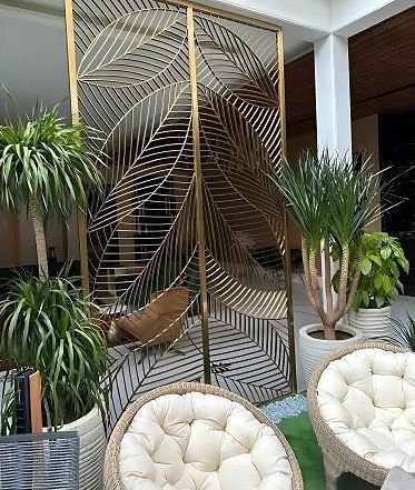 Brass palm-leaf screen on a hotel terrace