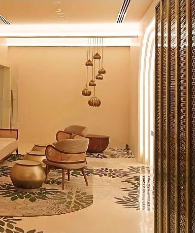 Brass perforated partition dividing a hotel lounge