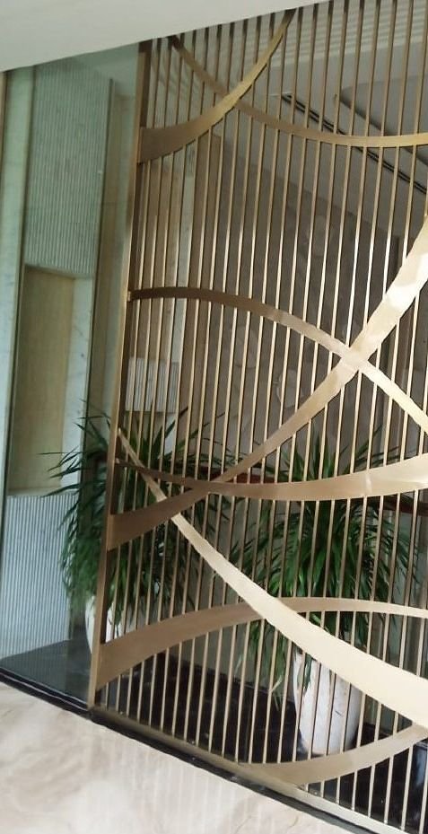 Brass ribbon screen across a staircase void