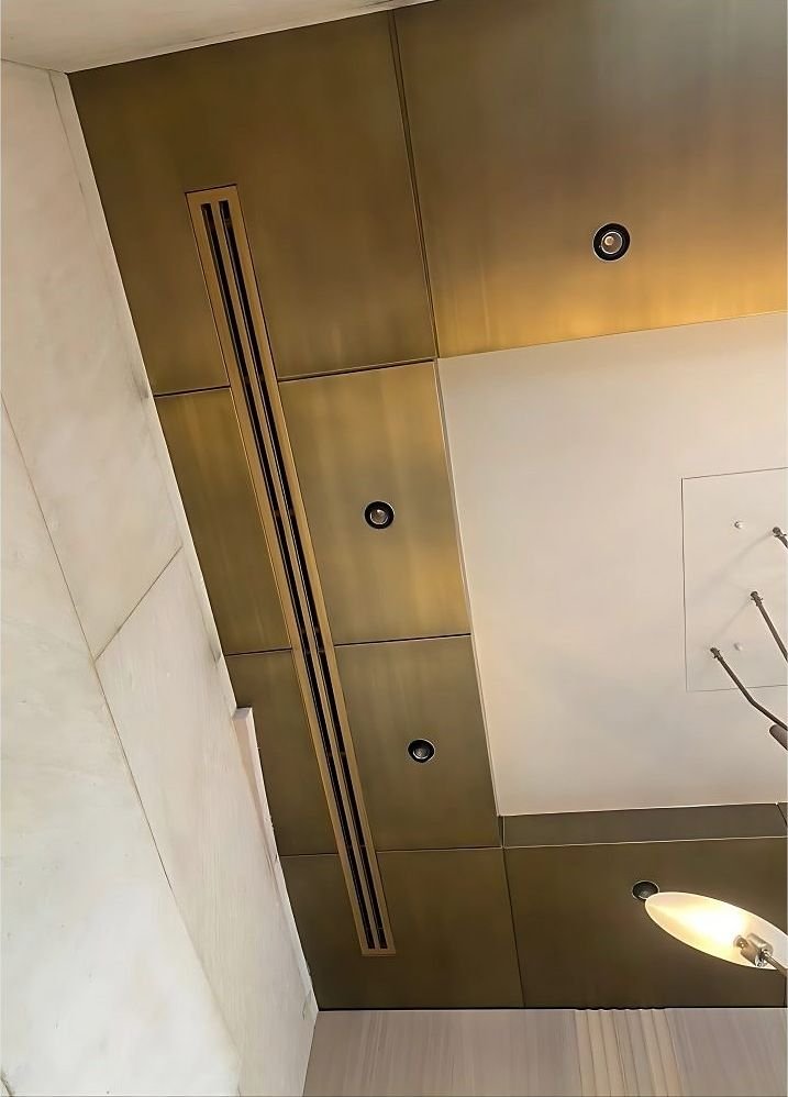 Brass wall panelling with a recessed linear light slot