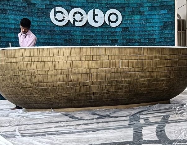 Detail of the woven brass face of a reception desk