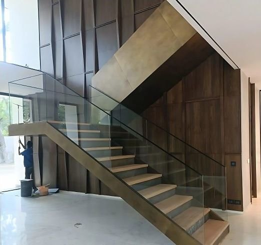 Bronze-clad staircase with a glass balustrade