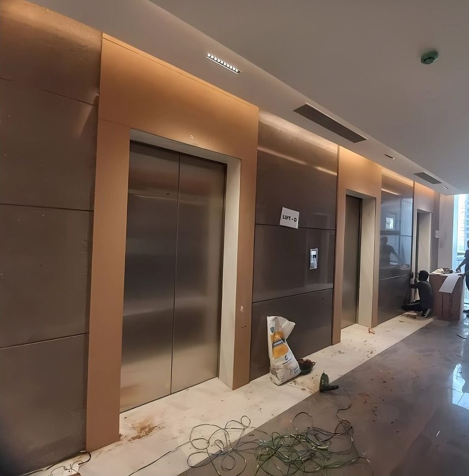 Bronze lift surround along a hotel corridor