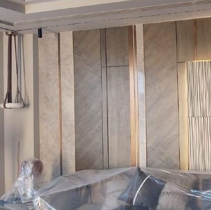 Bronze wall panels being installed on site