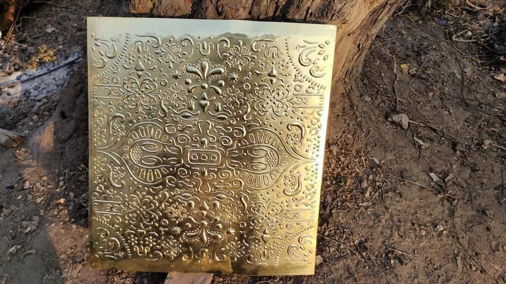 Cast and embossed metal sample