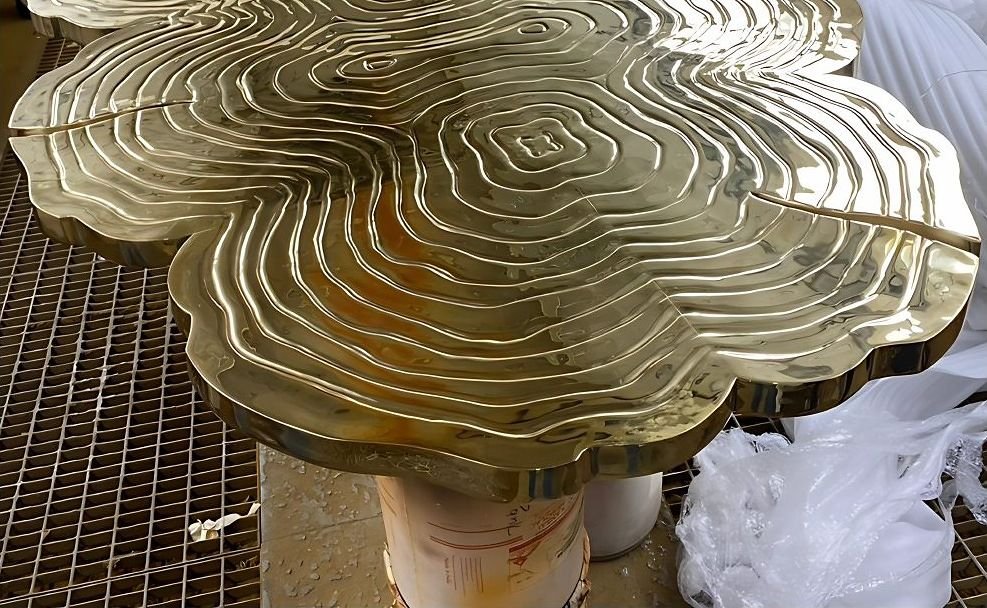 Cast brass centre table with an organic rippled top