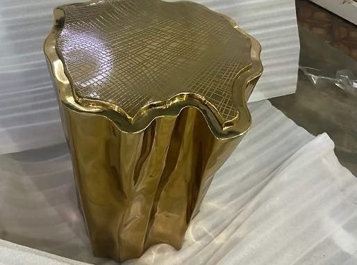 Cast brass side table shaped like a sectioned tree stump