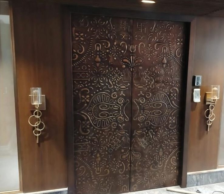 Embossed copper entrance doors to a residence