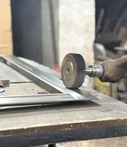 Hand-polishing the edge of a metal frame