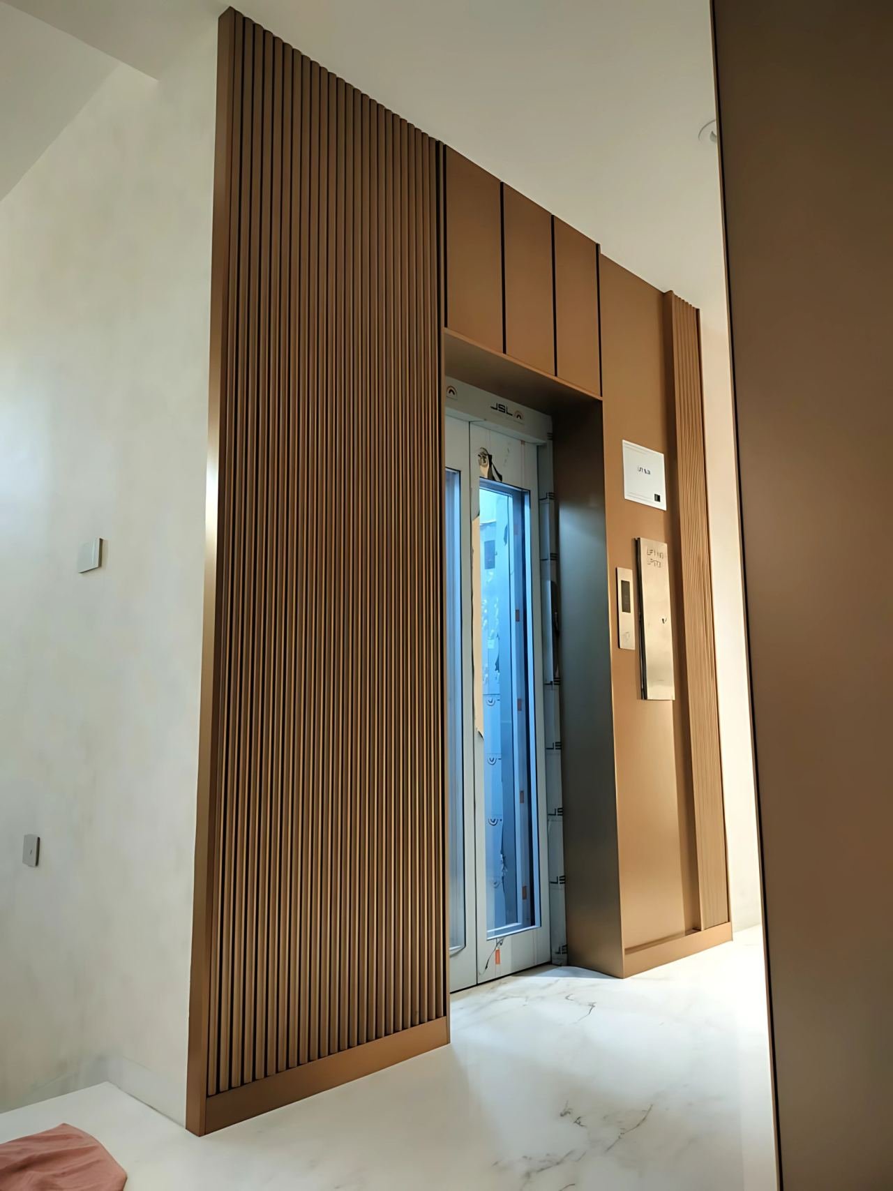 Lift door cladding and lobby panelling