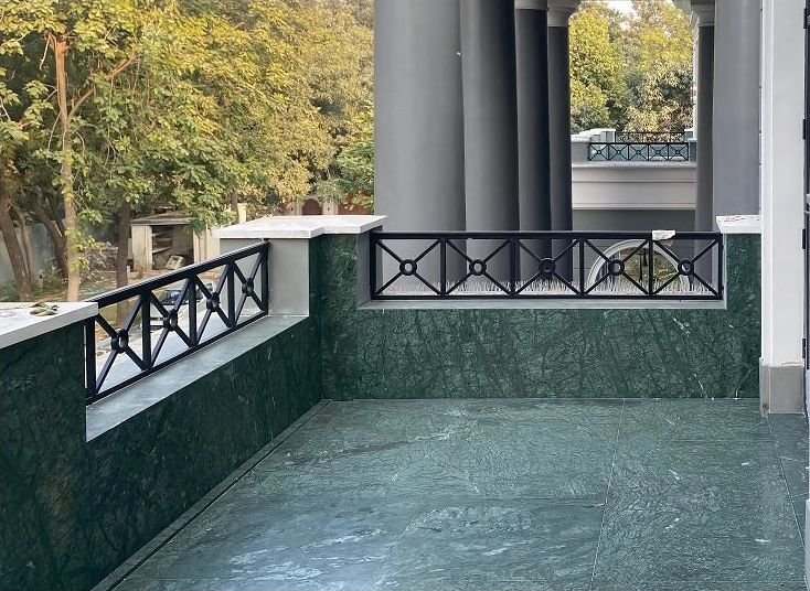 Metal balustrade around a marble courtyard