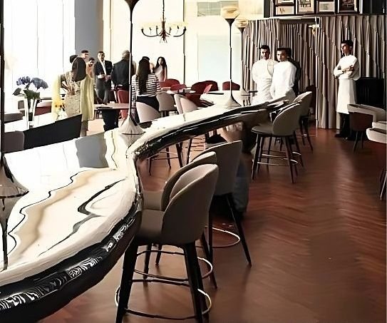 Long metal-edged bar counter with bar stools in a hotel restaurant
