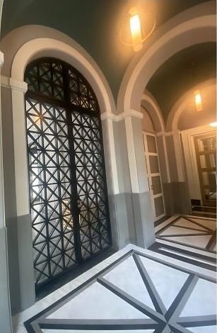 Metal screen doors set in an arched entrance