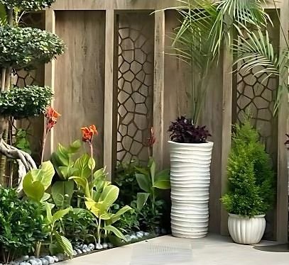 Metal screen panels on a planted courtyard wall