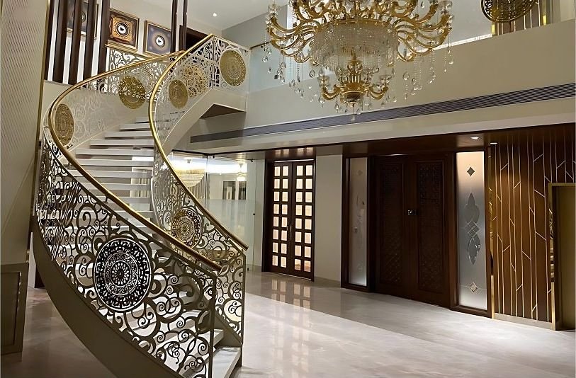 Ornate gold balustrade on a curved staircase