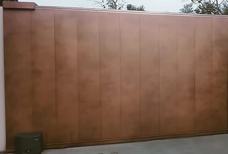 Patinated copper cladding on a boundary wall