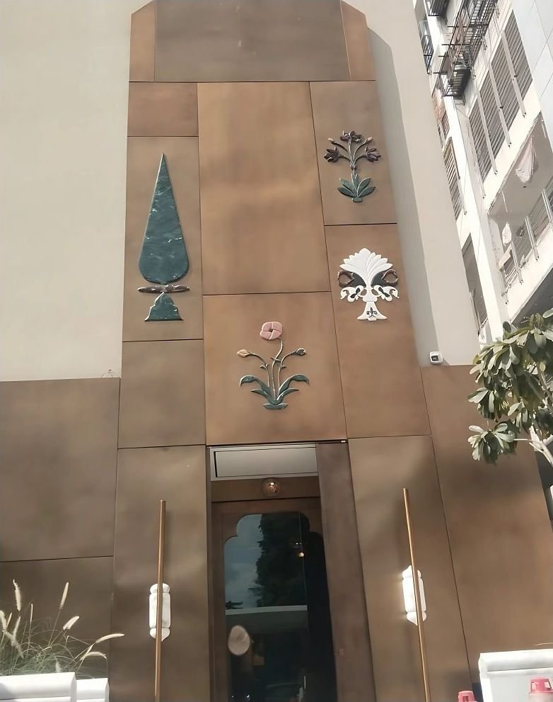 Patinated copper facade with inlaid motifs