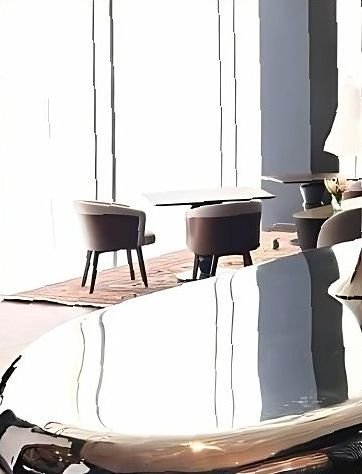 Close view of a mirror-polished stainless steel table edge