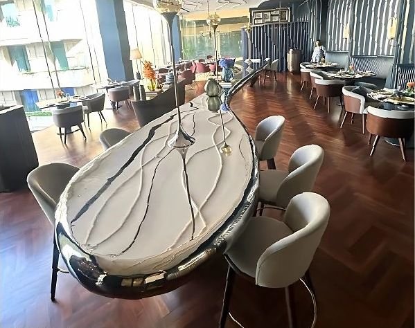 Polished stainless steel and marble bar counter in a fine-dining restaurant
