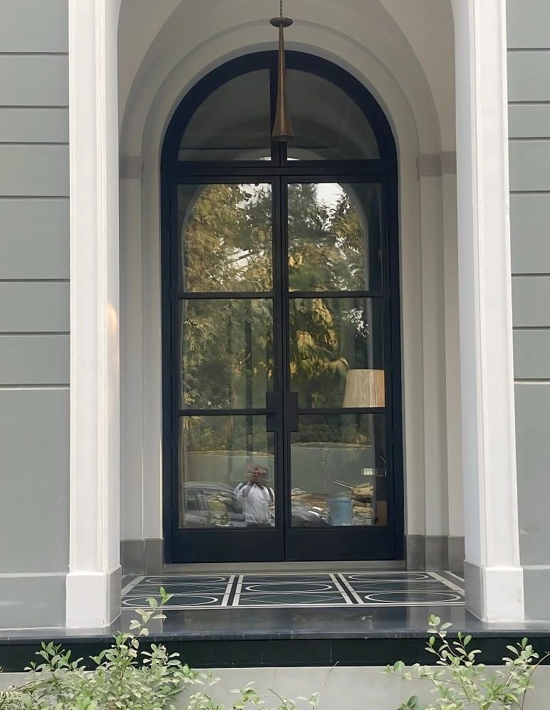 Steel-framed glazed entrance doors to a villa