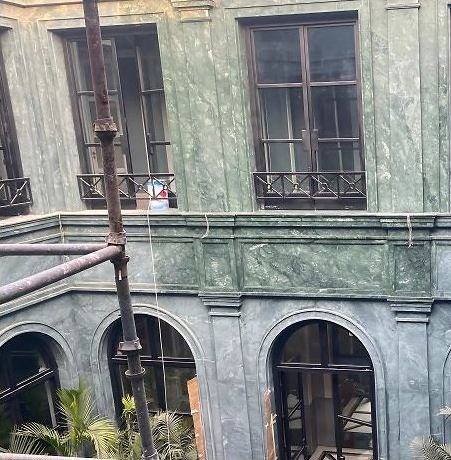 Steel windows and balconies in a marble courtyard