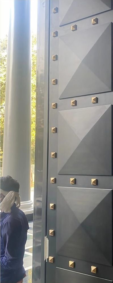 Studded faceted metal entrance door panel