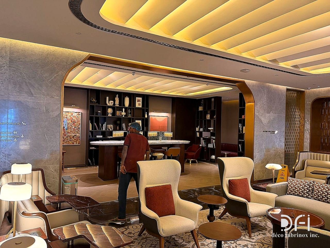 Airport lounge seating under a stepped, lit ceiling
