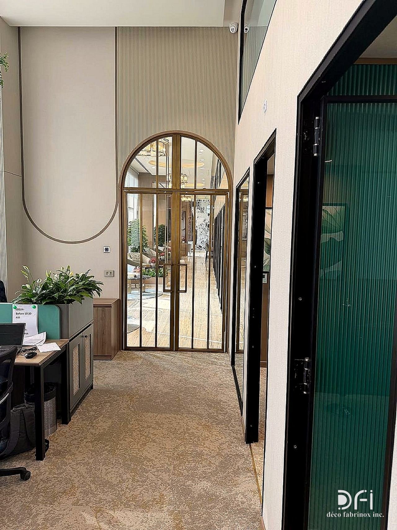 Arched brass-framed glass door at the end of an office corridor