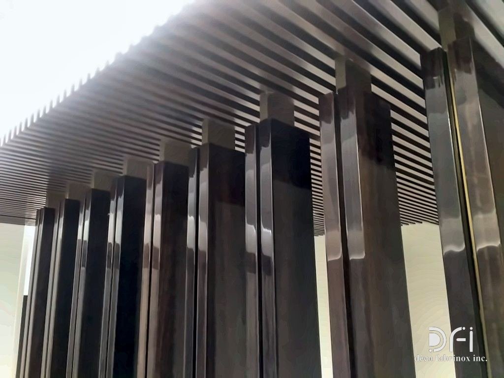 Tall dark metal fins under a slatted canopy