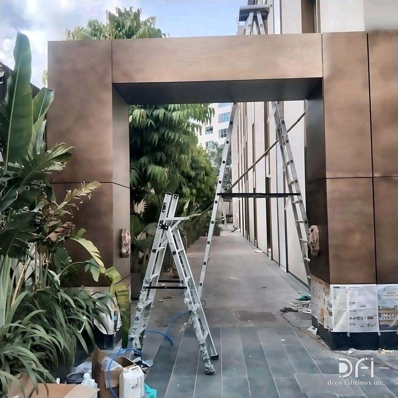 Bronze-clad entrance portal under installation