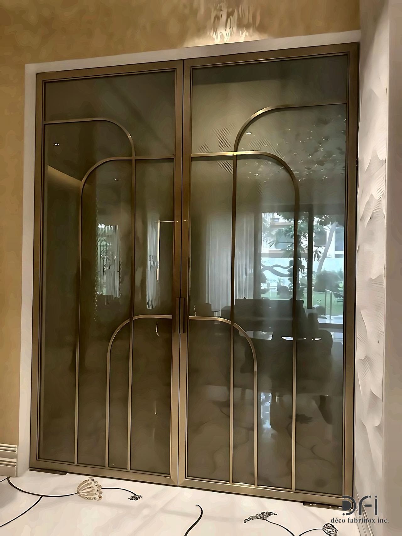 Bronze-framed glass doors with arched inlay lines