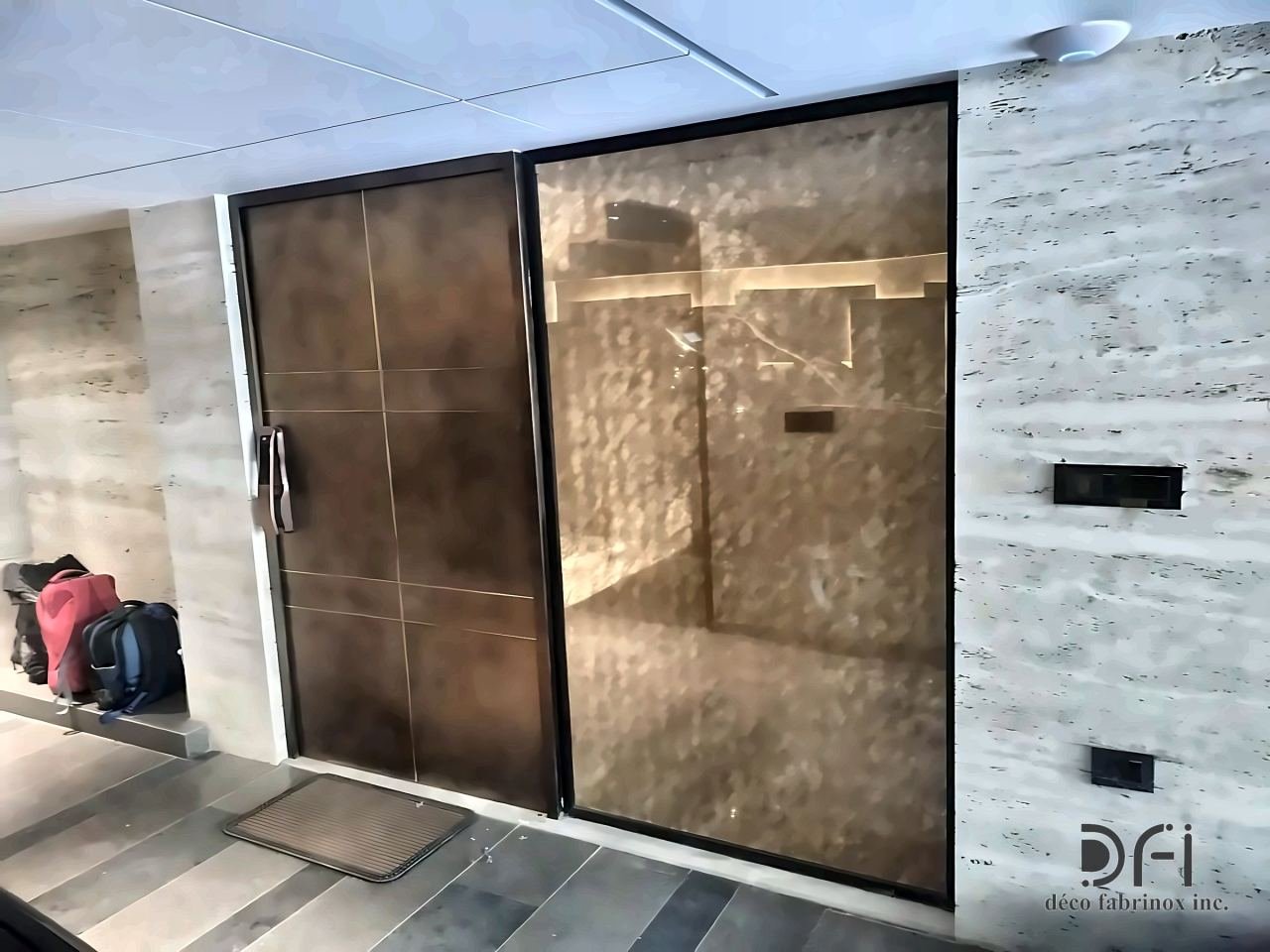 Bronze-clad door and textured metal panel at an entrance