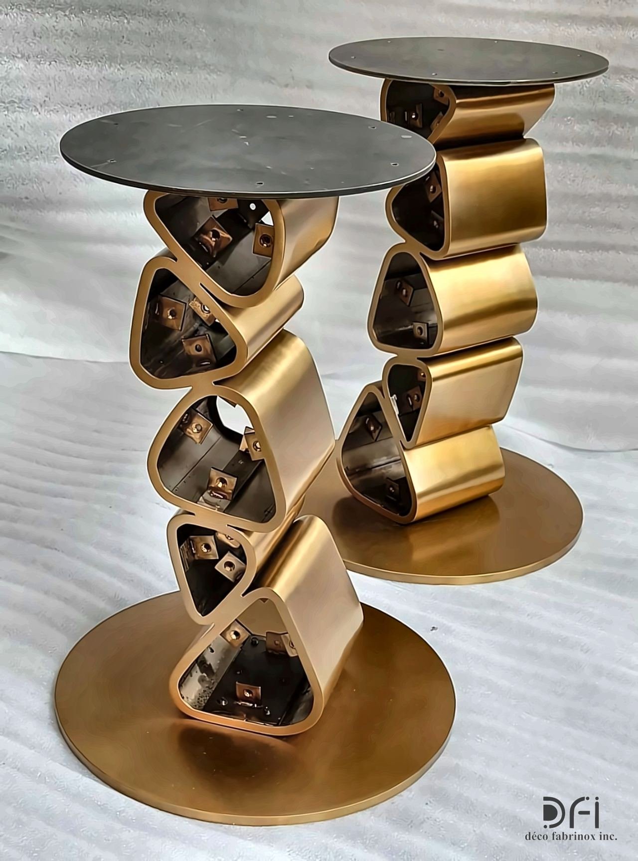 Pair of brass side tables with stacked triangular frames