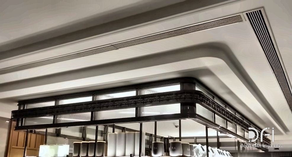 Blackened steel framework detail against a curved plaster ceiling