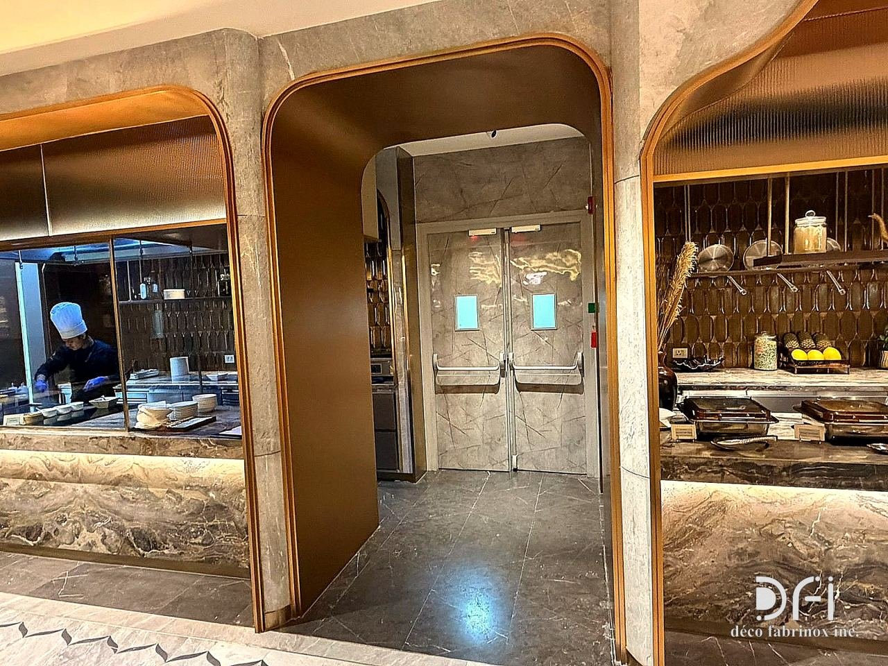 Brass arch portal between buffet counters in an airport lounge