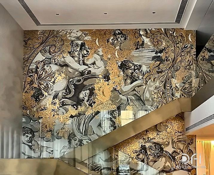 Brass balustrade beside a gold mural staircase