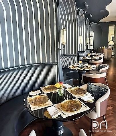 Restaurant seating booth with brass detailing and fluted metal panelling