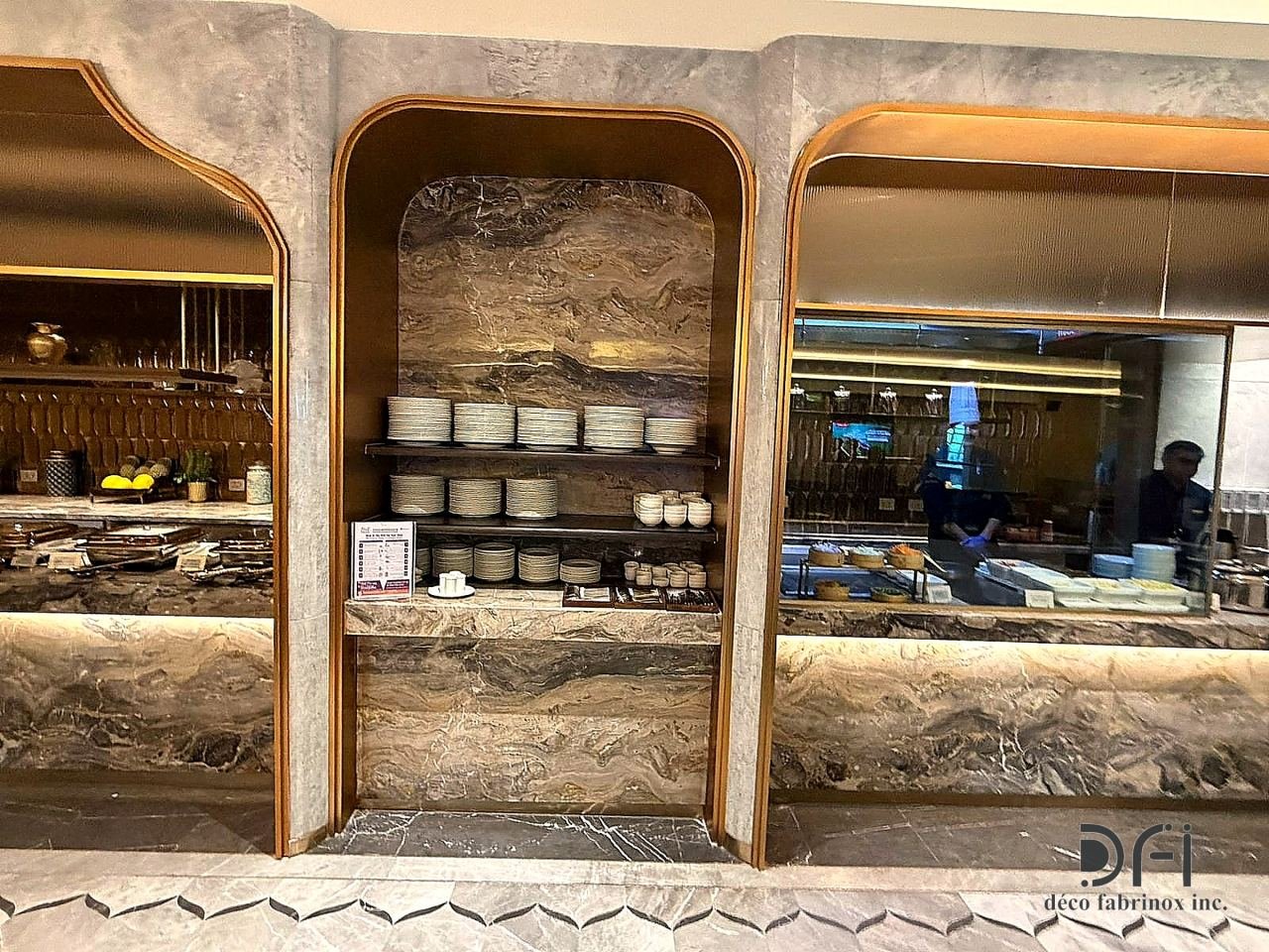 Brass-edged arches framing the buffet counters of an airport lounge