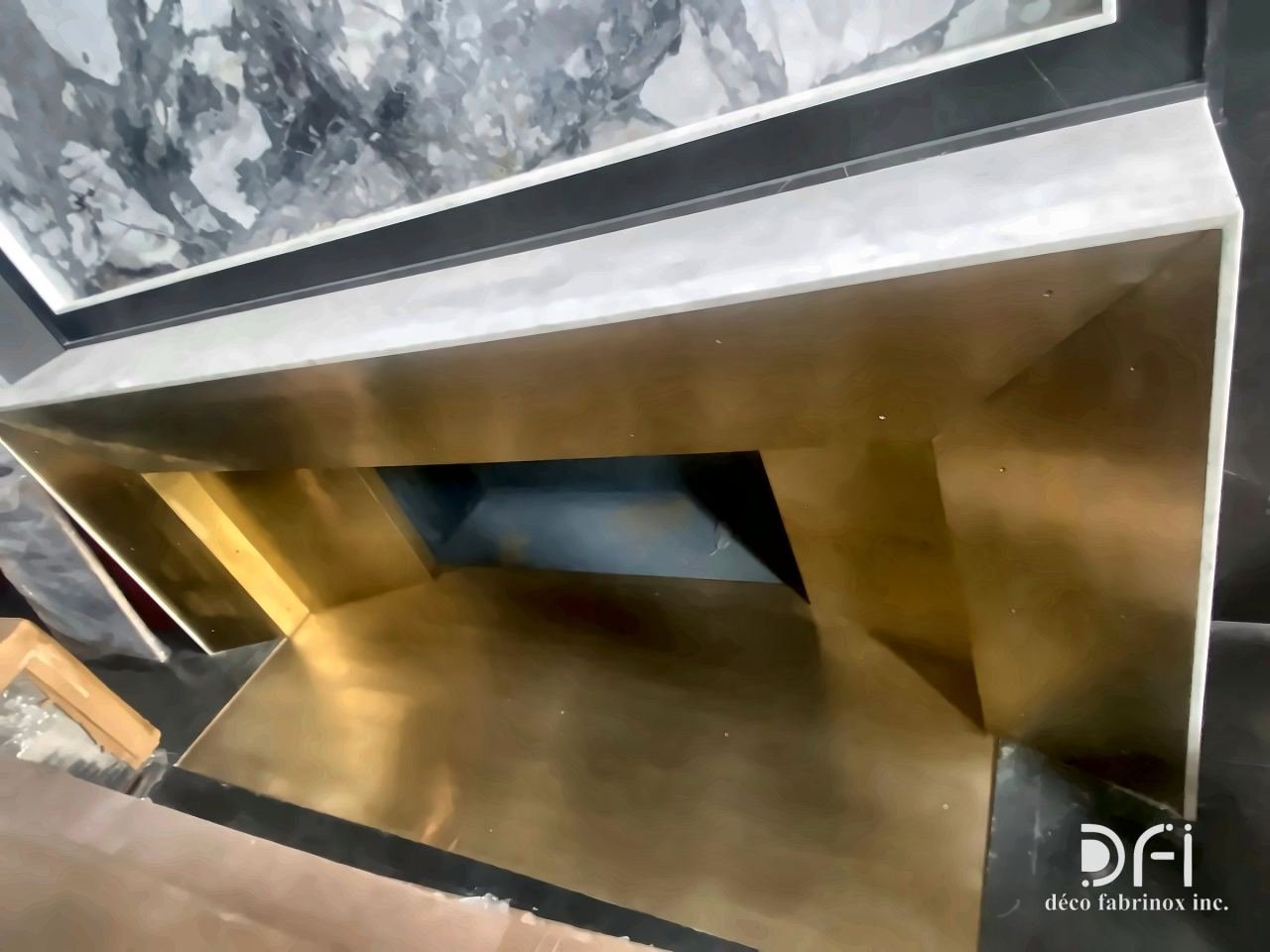 Brass-lined fire box beneath a marble hearth